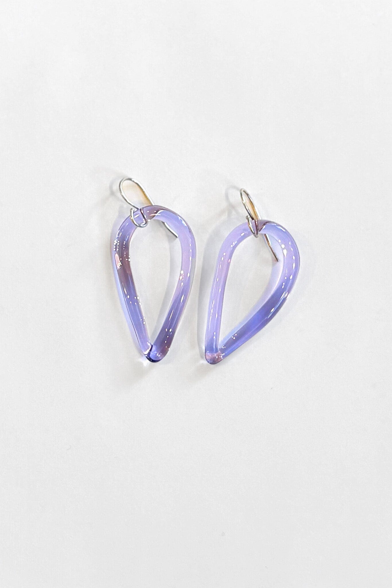 Pair of light purple teardrop-shaped earrings on a white background