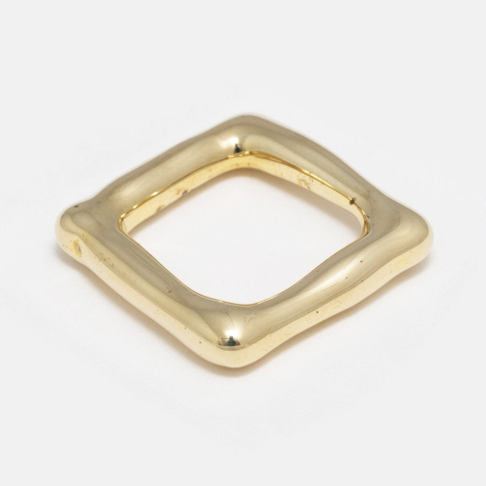 A solid heavy brass organic square band, likely a ring, with a smooth finish.
