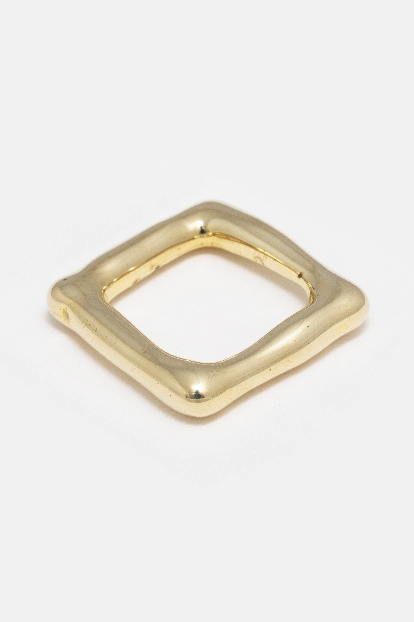 A solid heavy brass organic square band, likely a ring, with a smooth finish.