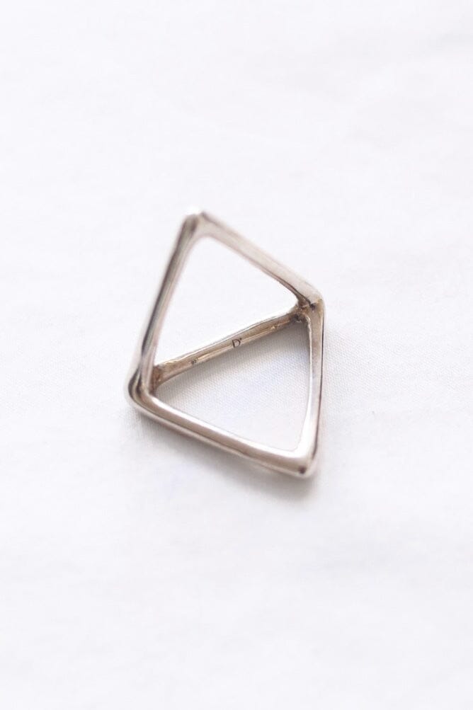 A silver double triangle ring against a white background.