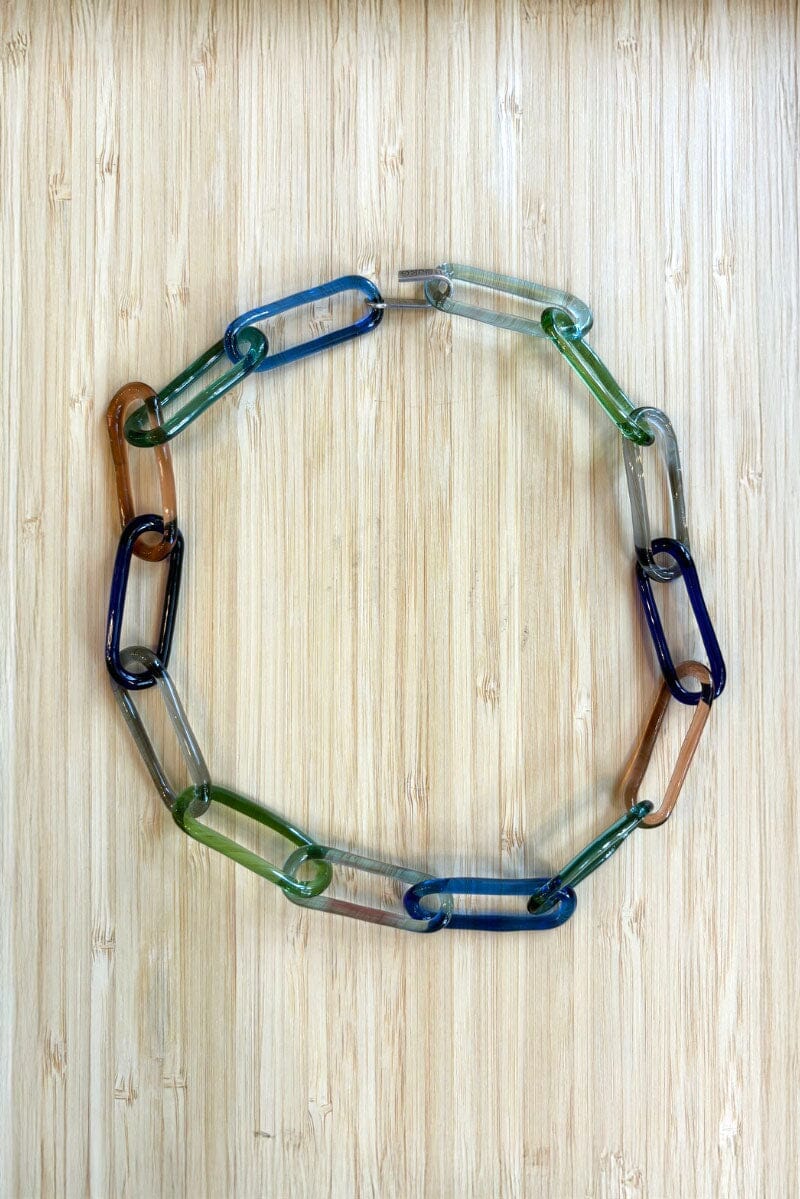 Colorful glass chain necklace on a wooden surface