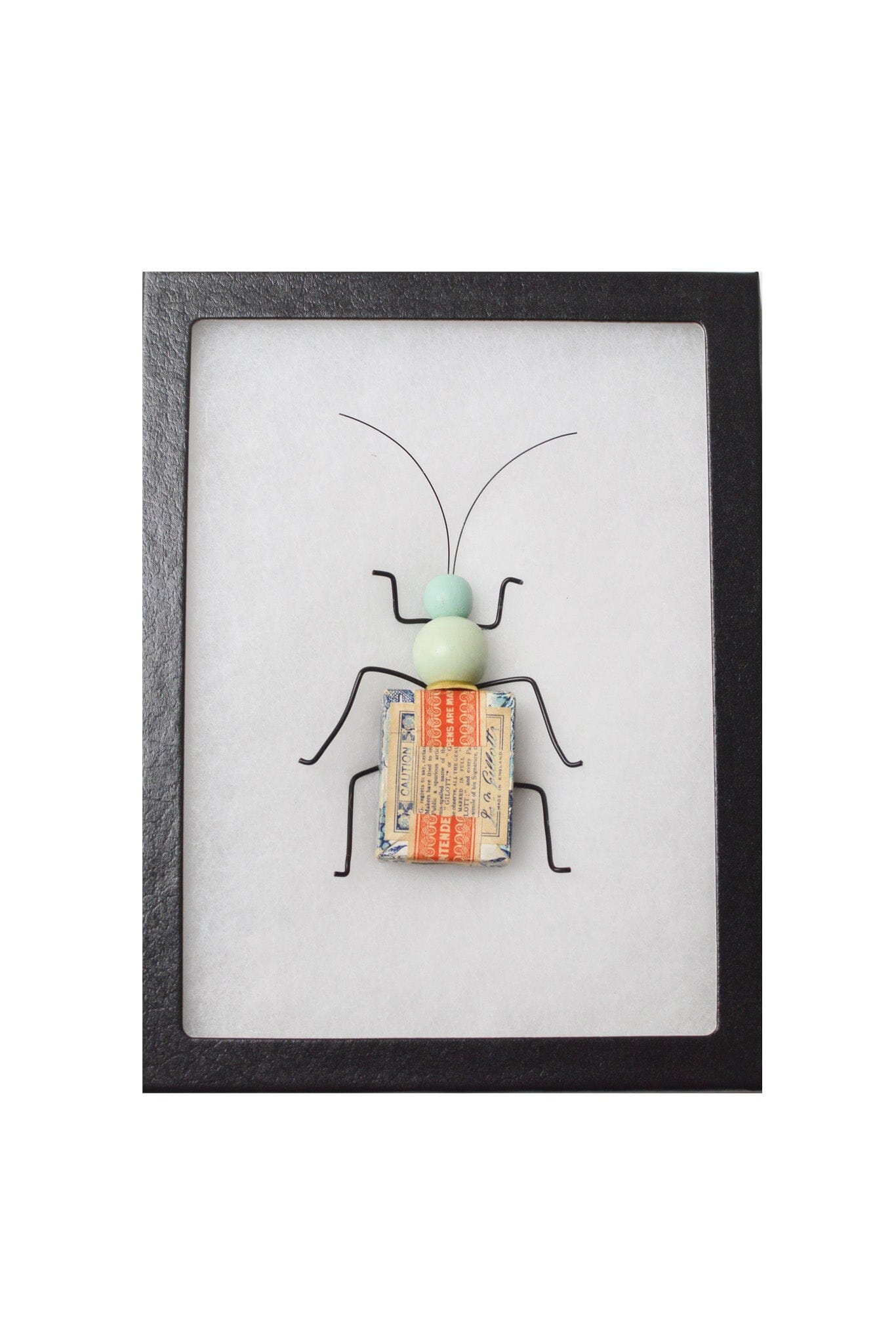 Framed artwork of a beetle-like insect on a white background