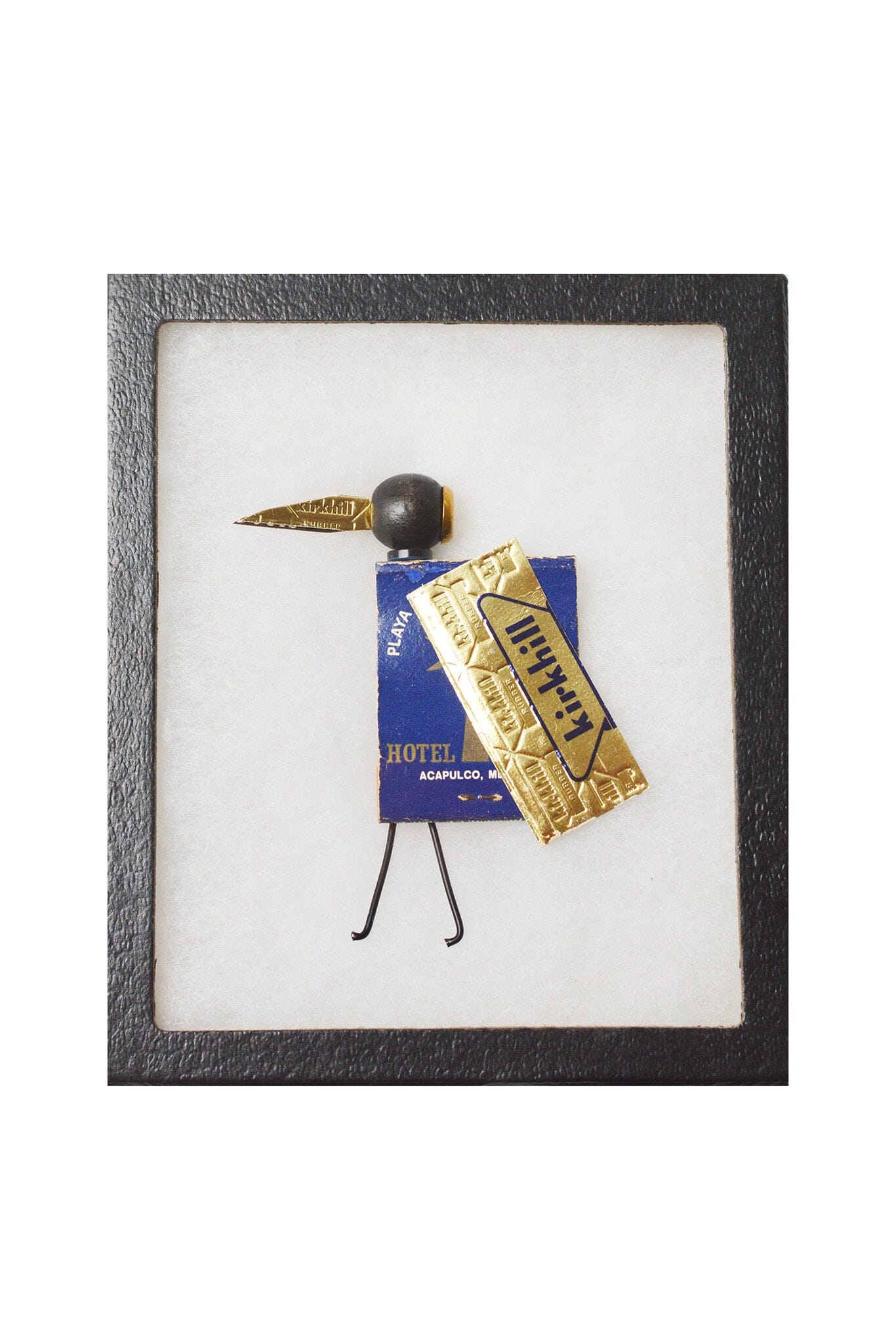 Framed art piece with a decorative object on a white background