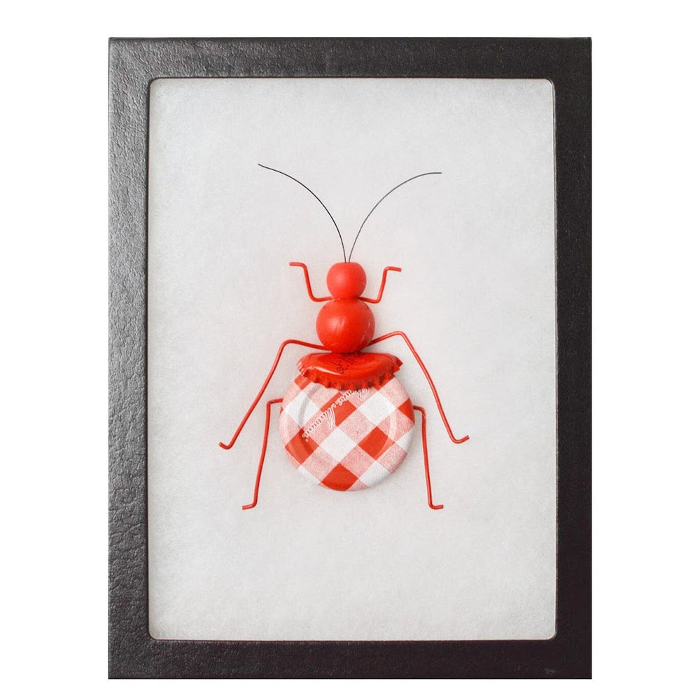 Framed artwork of a red and white checkered ant on a white background