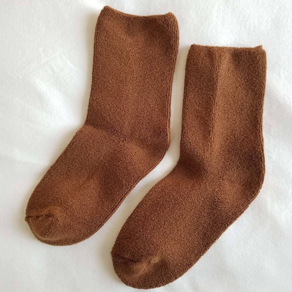 Pair of brown socks on a white background