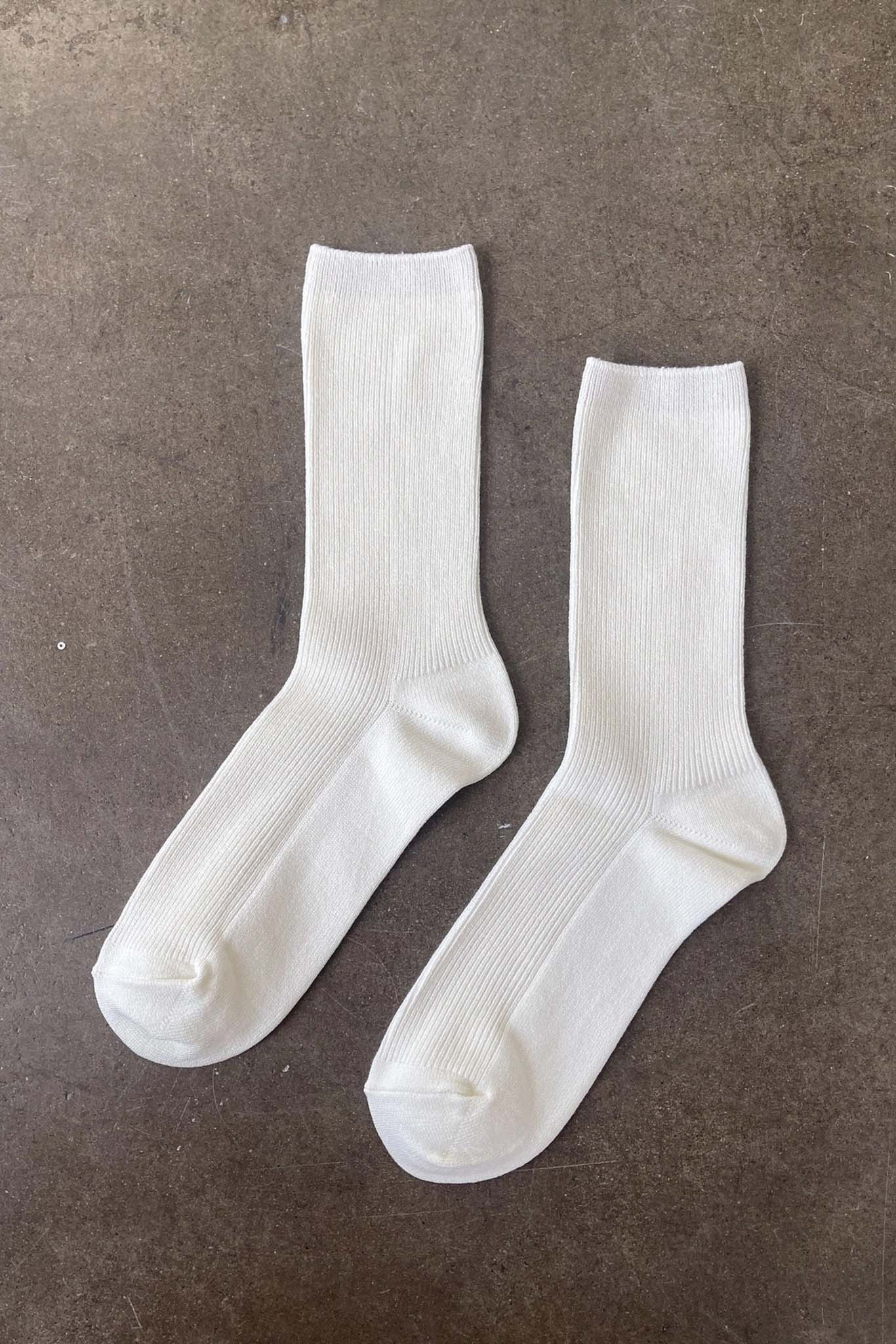 Pair of white socks on a brown surface