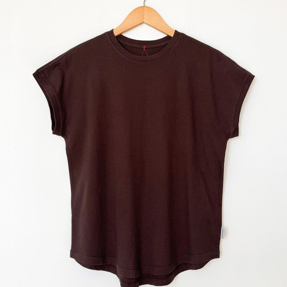 Brown t-shirt on a wooden hanger against a white background