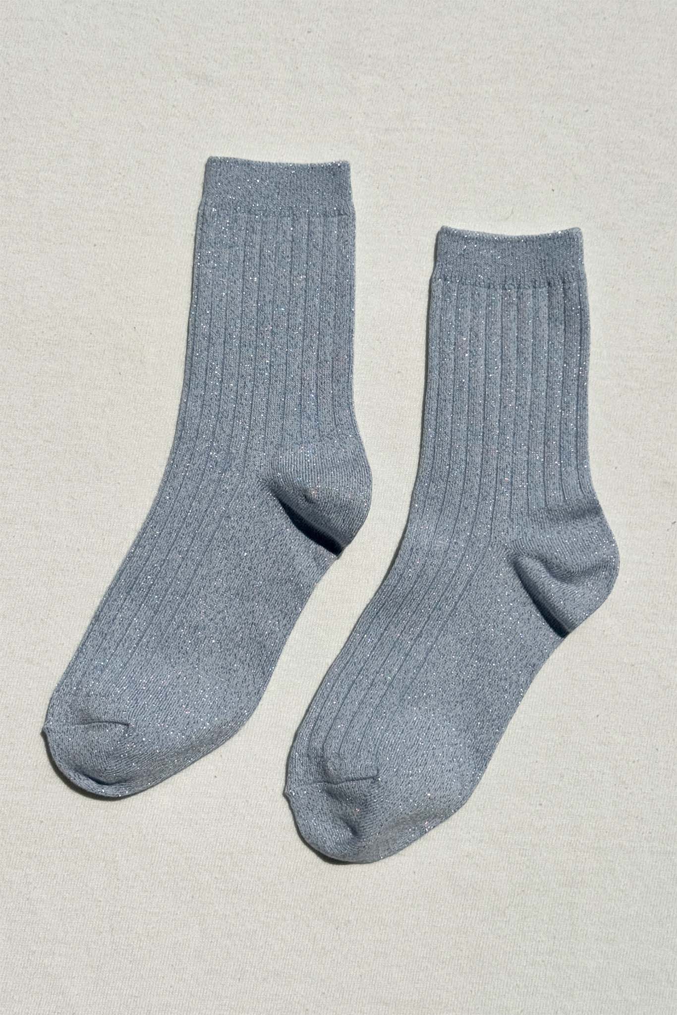 Pair of light blue socks on a beige background