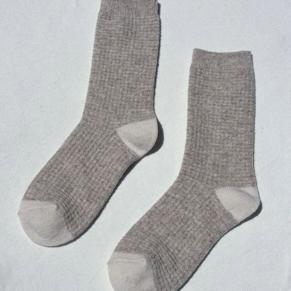 Pair of gray waffled socks on a light gray background