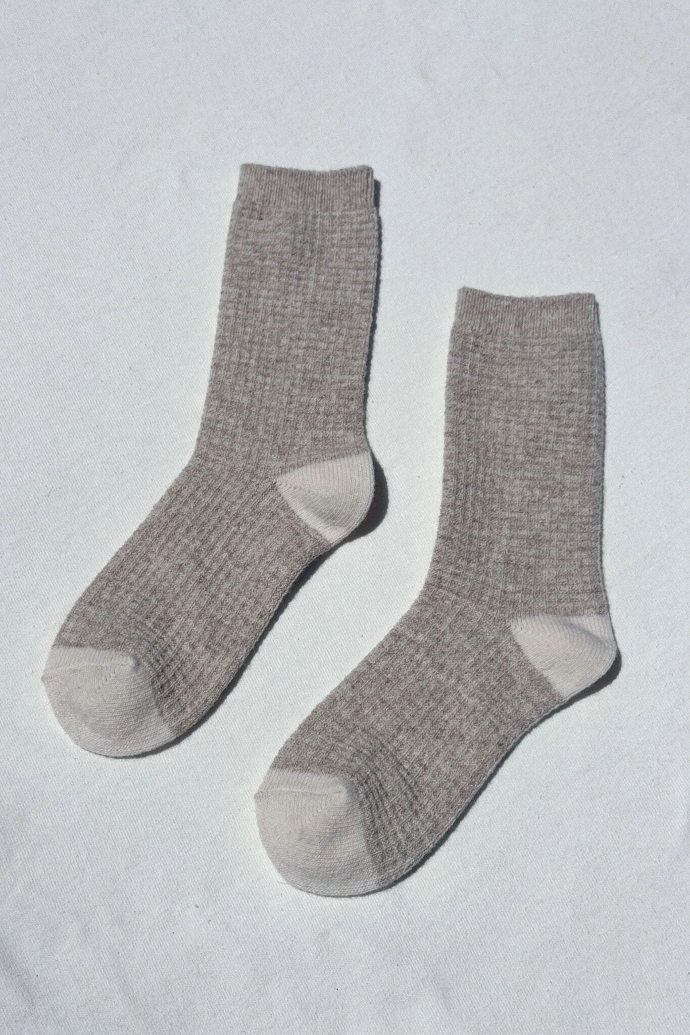Pair of gray waffled socks on a light gray background