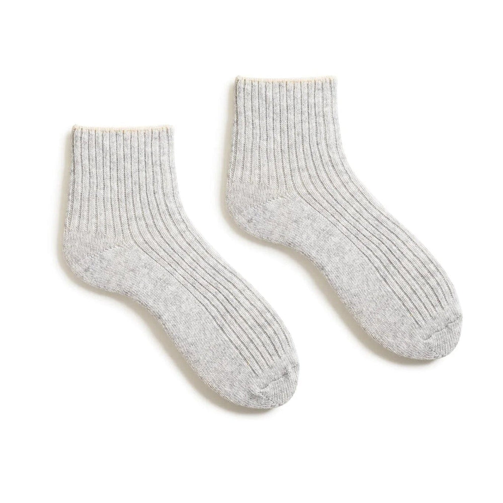 Pair of gray cashmere and wool socks on a white background