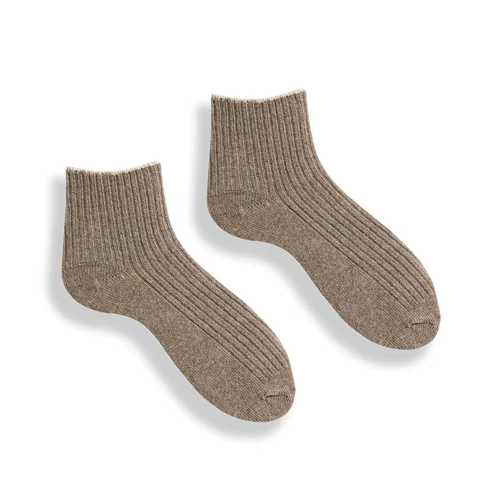 Pair of light brown cashmere and merino wool socks on a white background