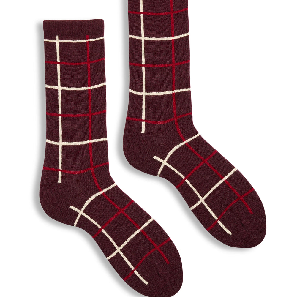 Pair of maroon socks with white grid pattern on a white background