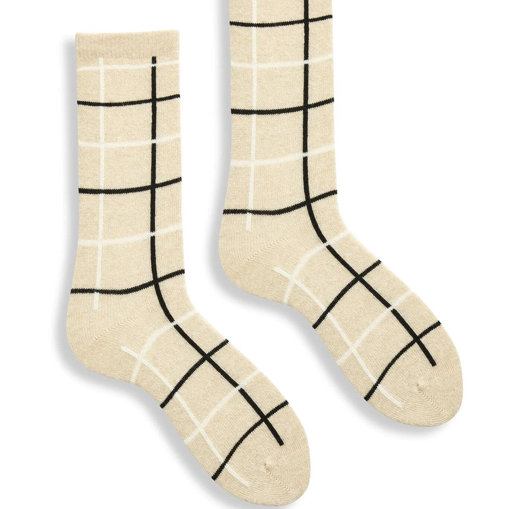 Pair of cream socks with black grid pattern on a white background