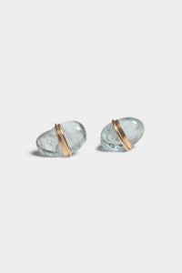 Pair of aqua stud earrings with gold accents on a light gray background