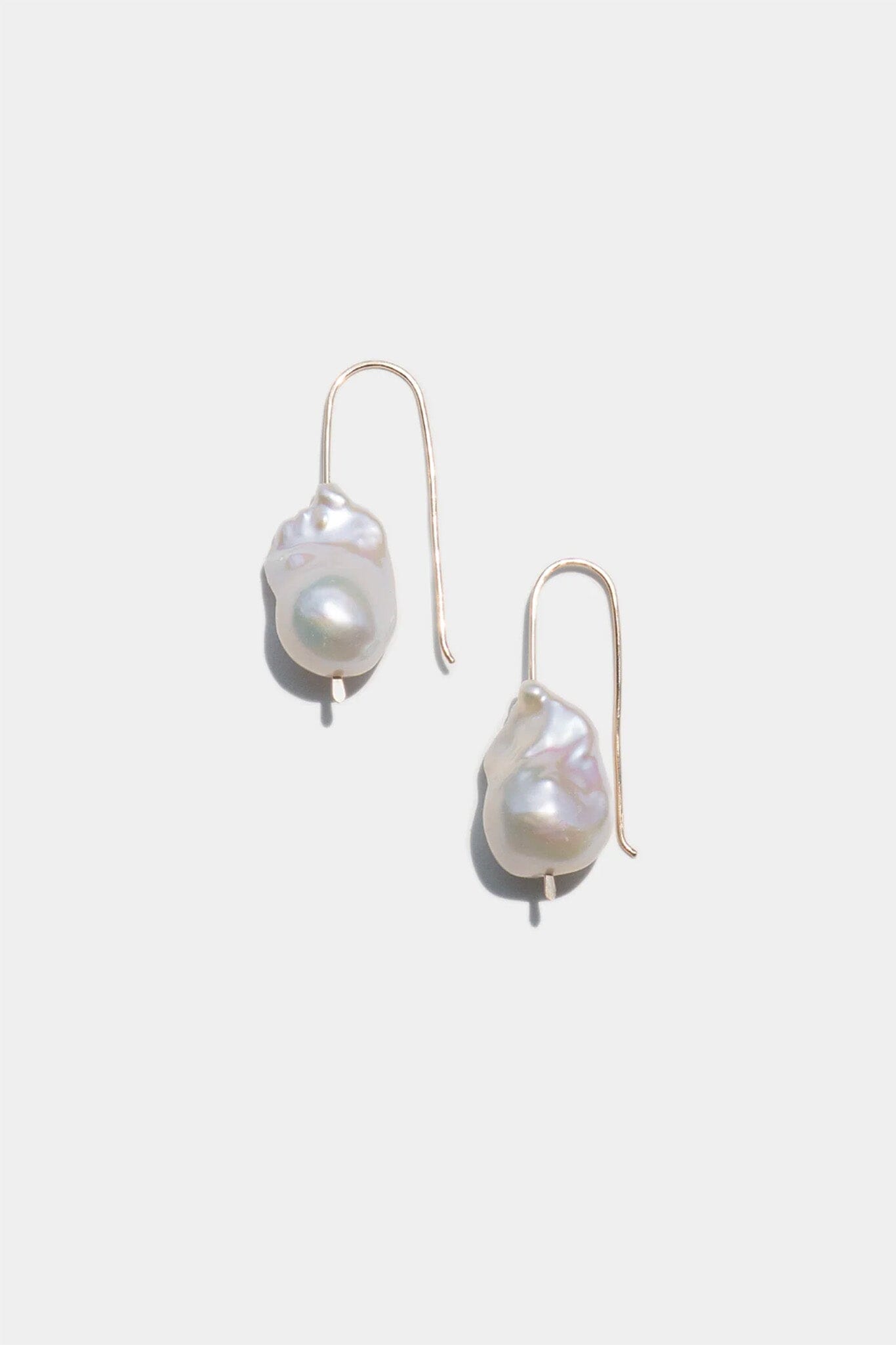 Pearl earrings on a light gray background