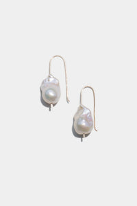 Pearl earrings on a light gray background