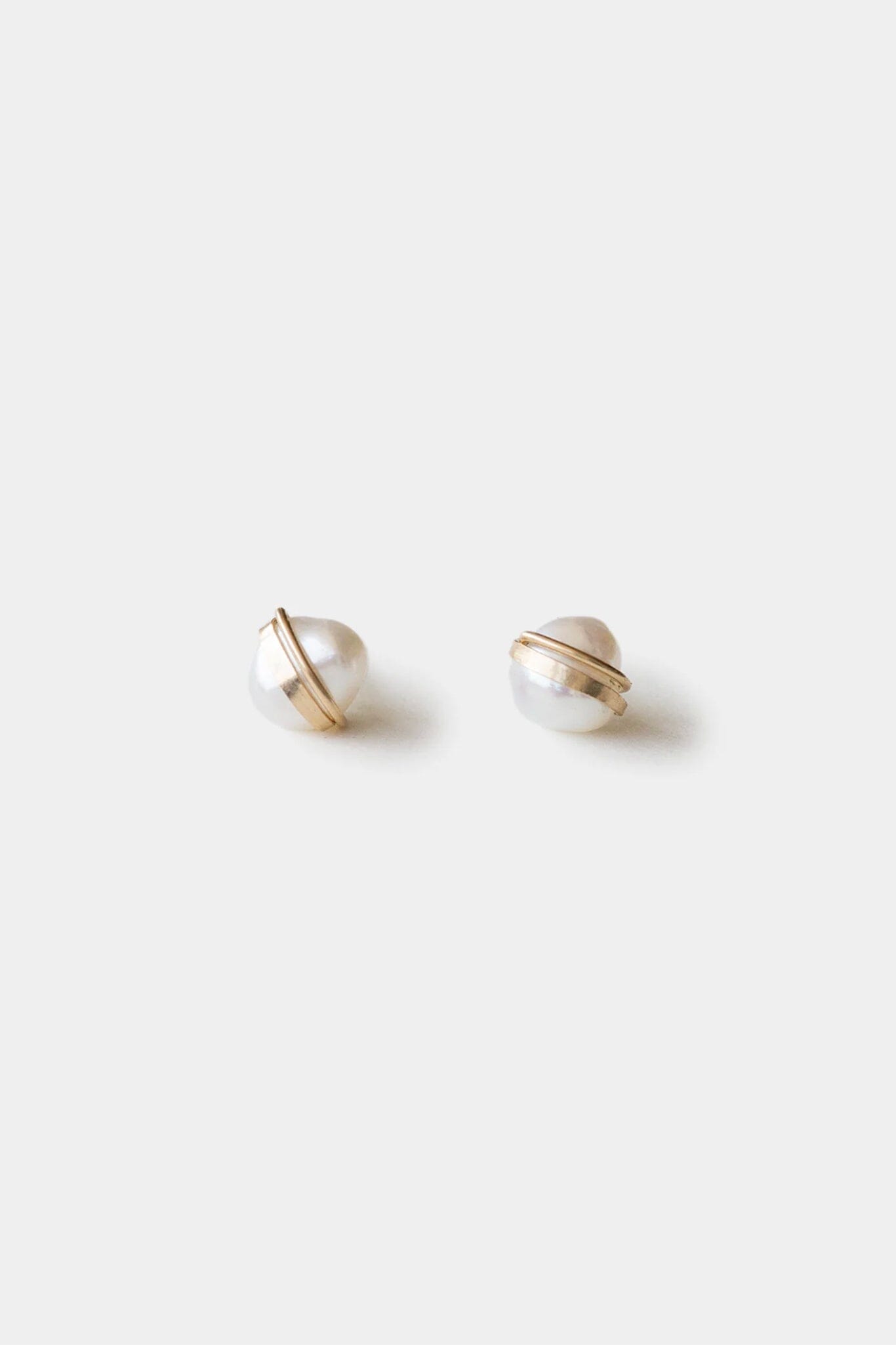 Pair of pearl stud earrings on a white background