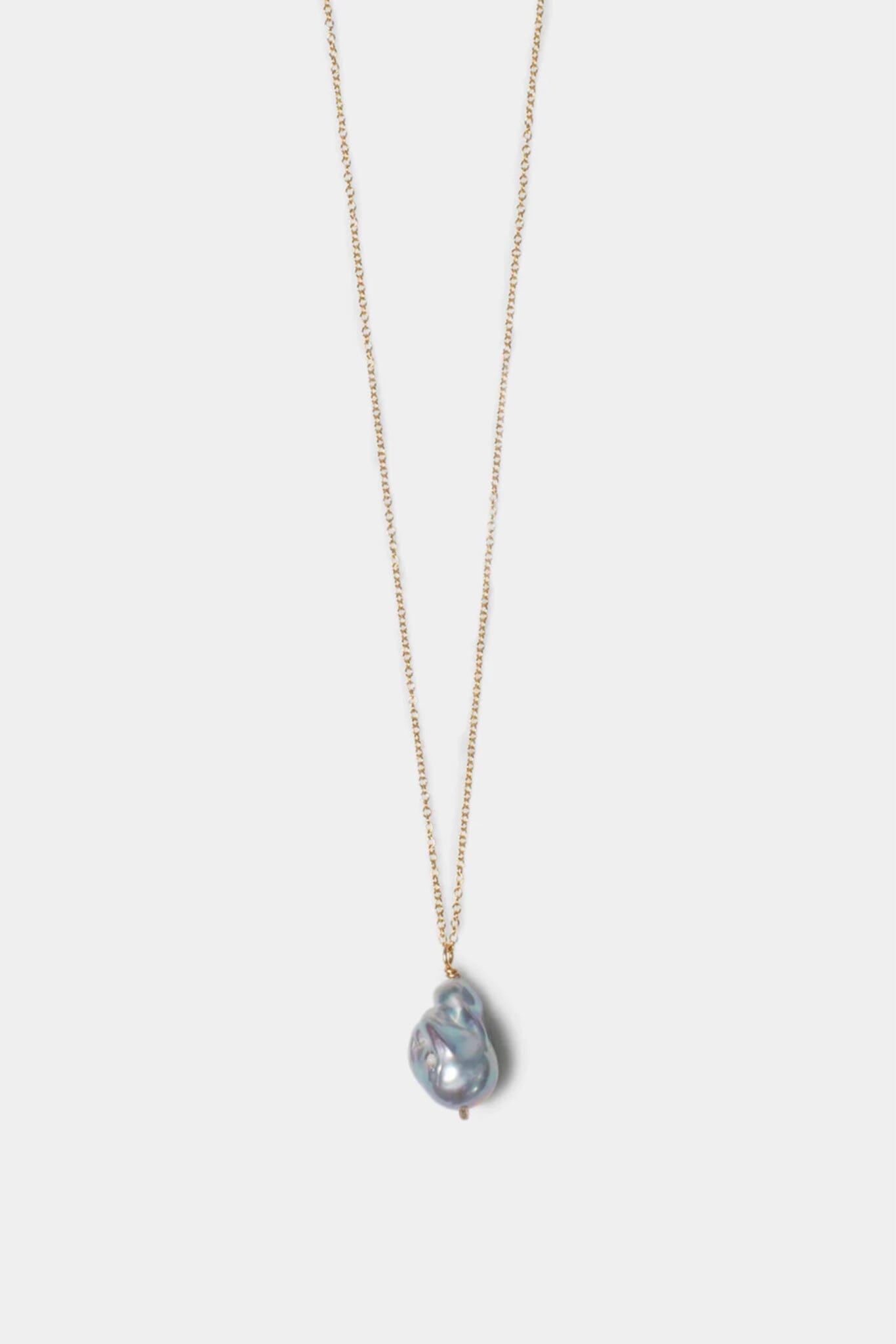 Gold necklace with an organic silver pearl pendant featuring a multicolored gemstone on a white background