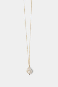 Pearl necklace on a thin gold chain against a white background