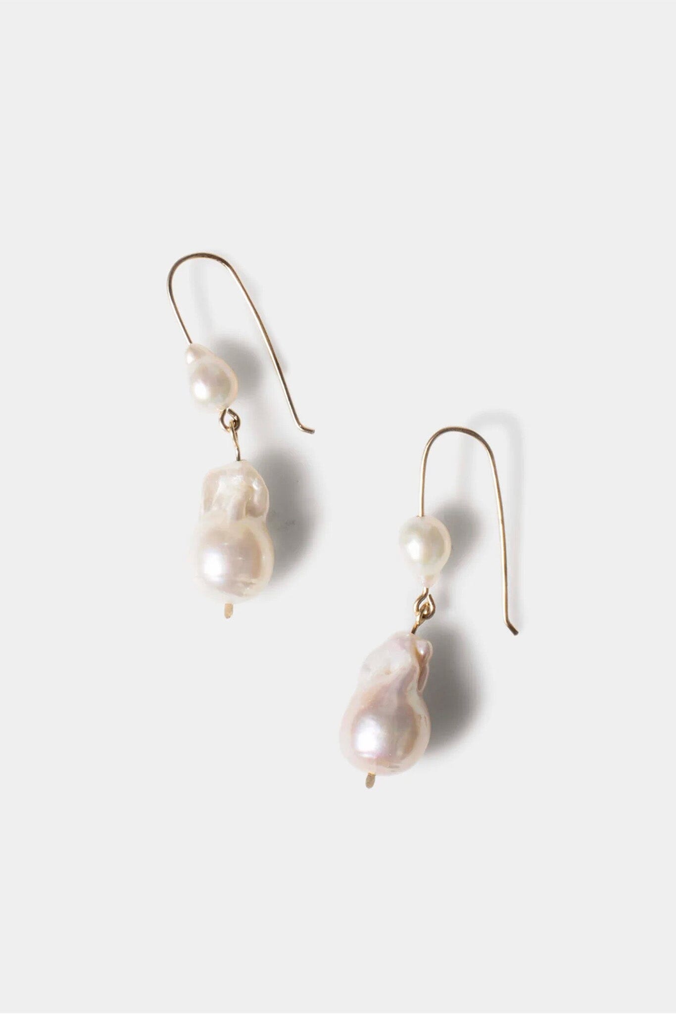 Pearl drop earrings on a white background