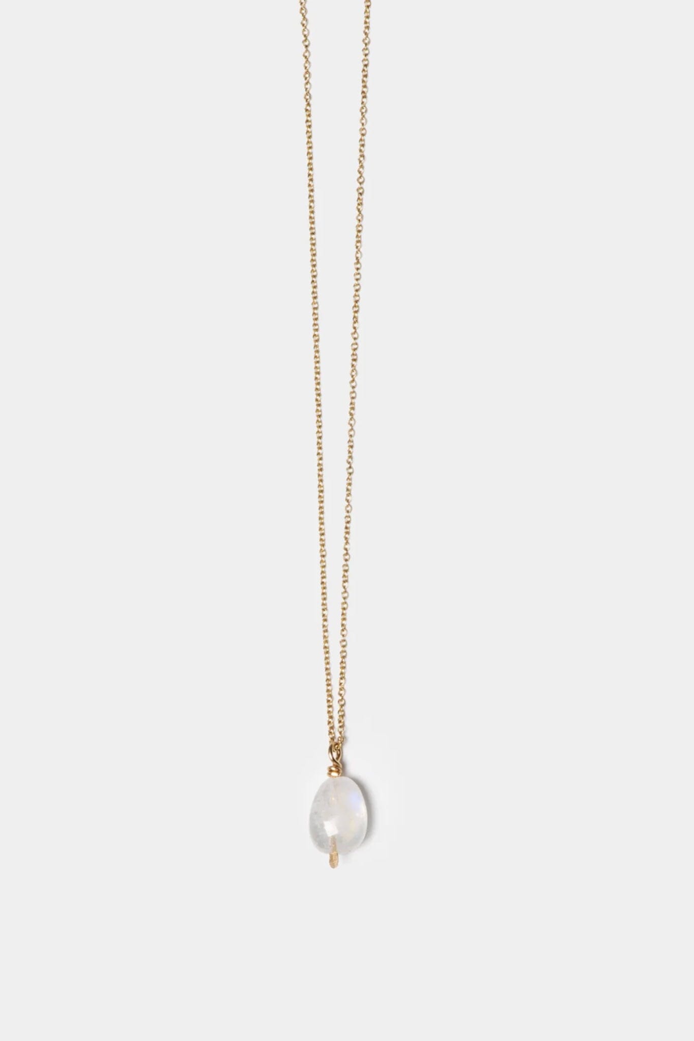 Faceted moonstone charm necklace on a thin chain against a white background