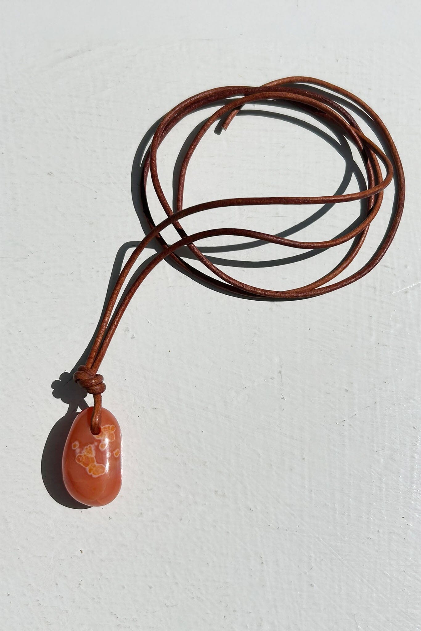 Carnelian oval cord necklace on a white background