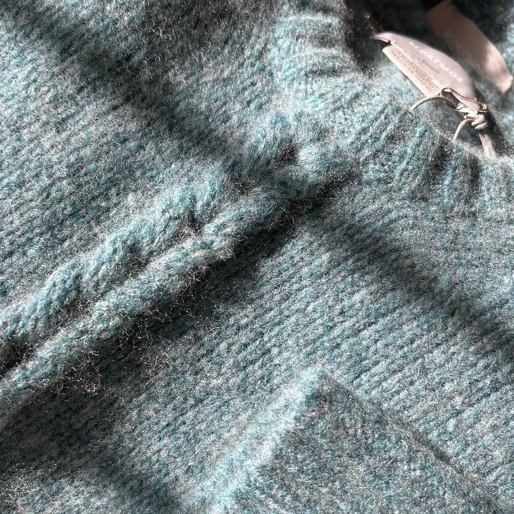 A close up of the Mies cashmere and merino wool sweater in a mineral green color