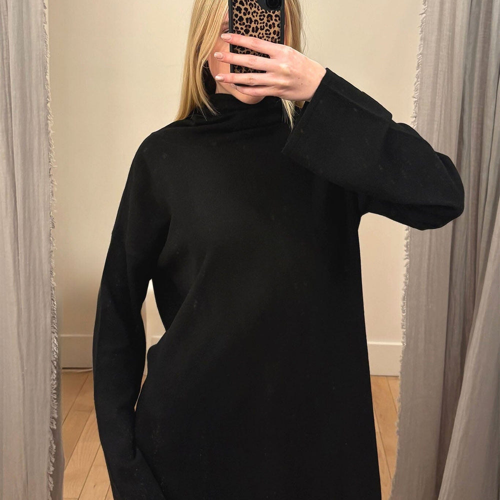 Woman wearing a black turtleneck sweater.