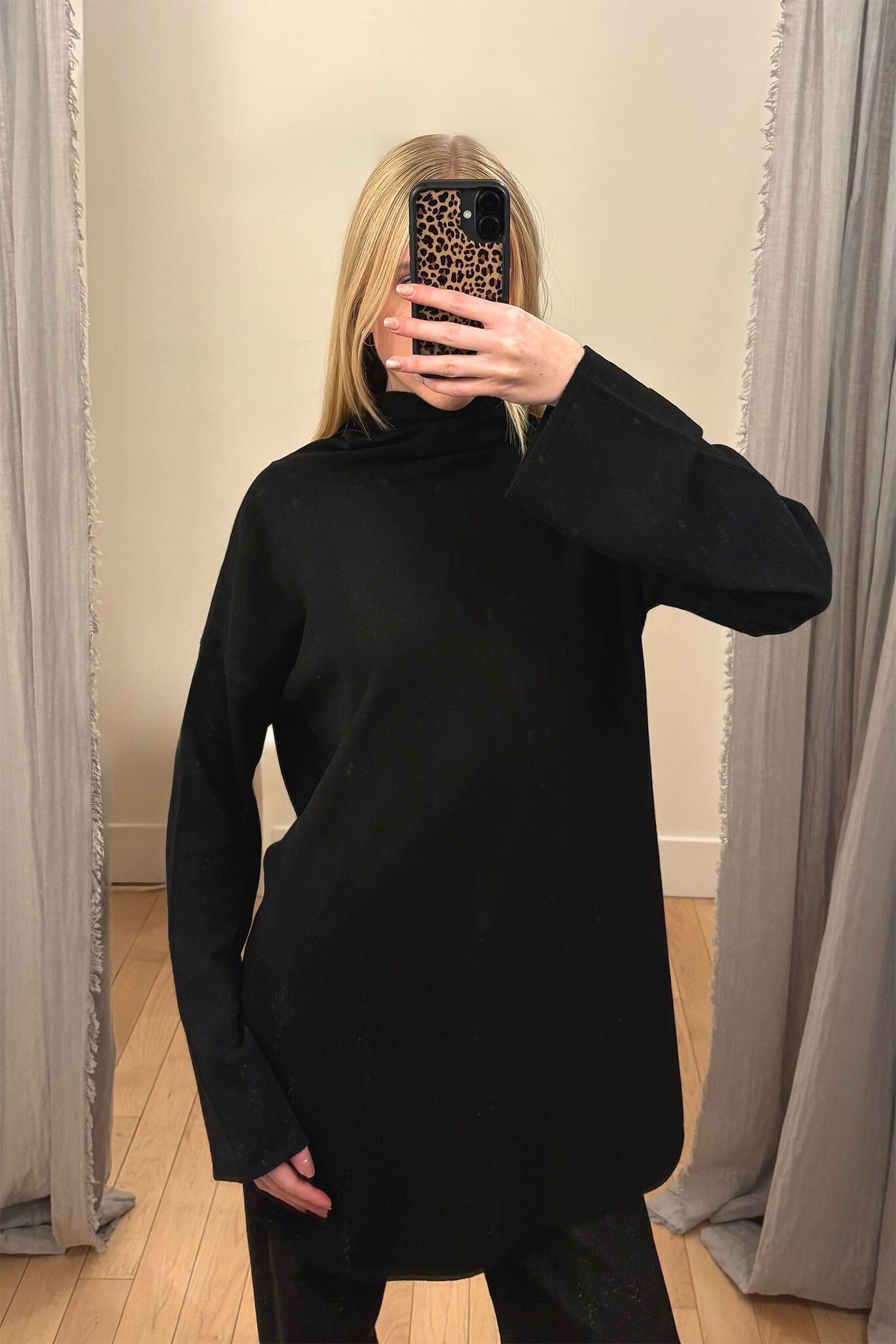 Woman wearing a black turtleneck sweater.