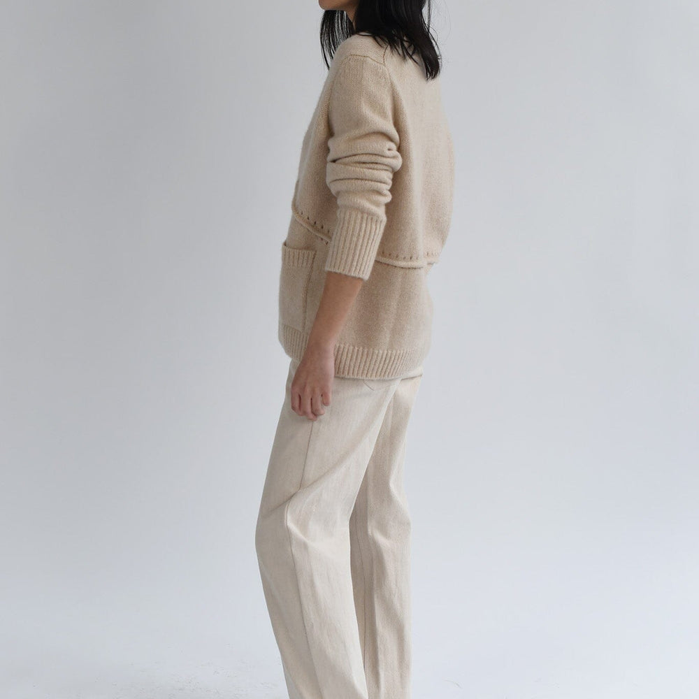 Wool and cashmere long sleeve sweater on a white background.