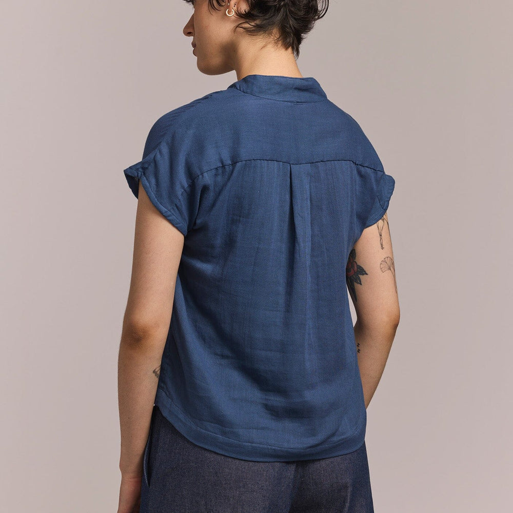 
                  
                    Person wearing a blue shirt and pants against a plain background
                  
                