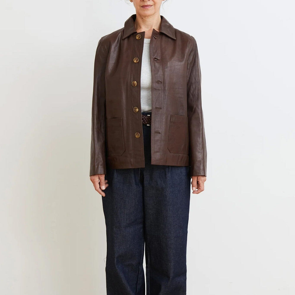 
                  
                    Person wearing a brown leather jacket and dark blue jeans against a white background
                  
                