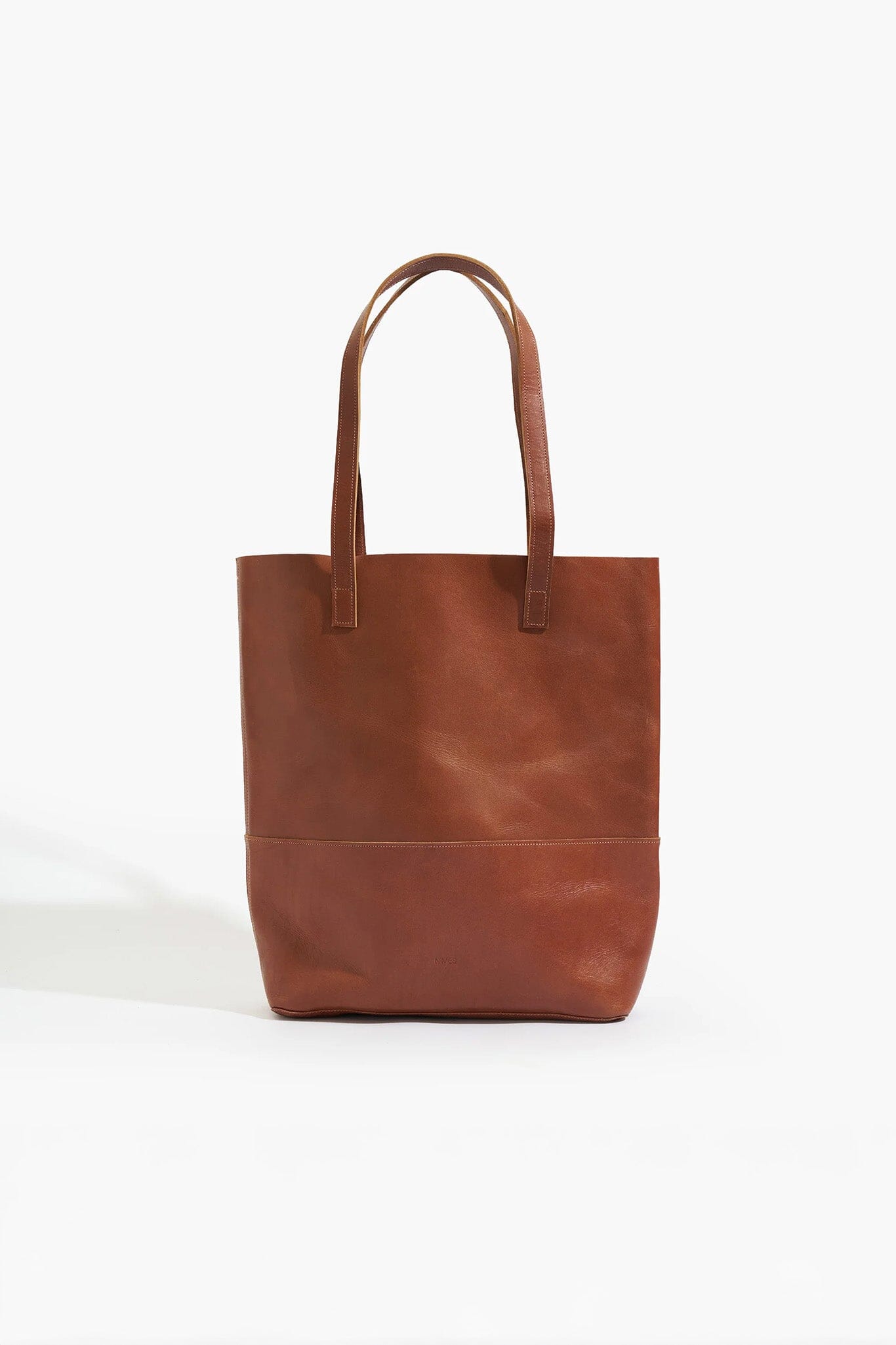 Brown leather tote bag on a white background
