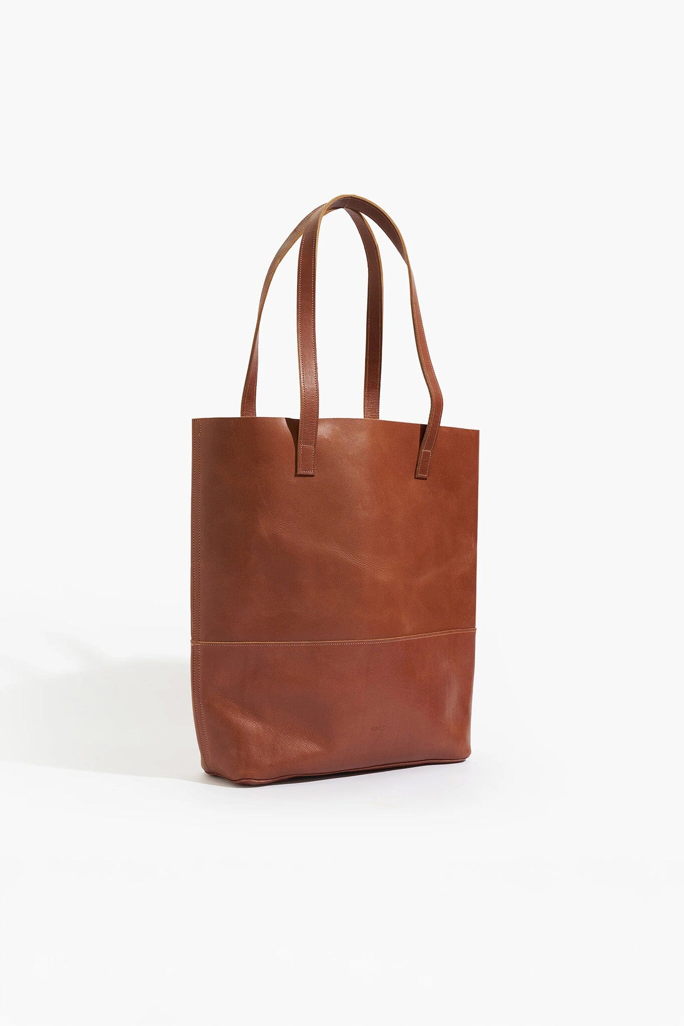 Brown leather tote bag on a white background