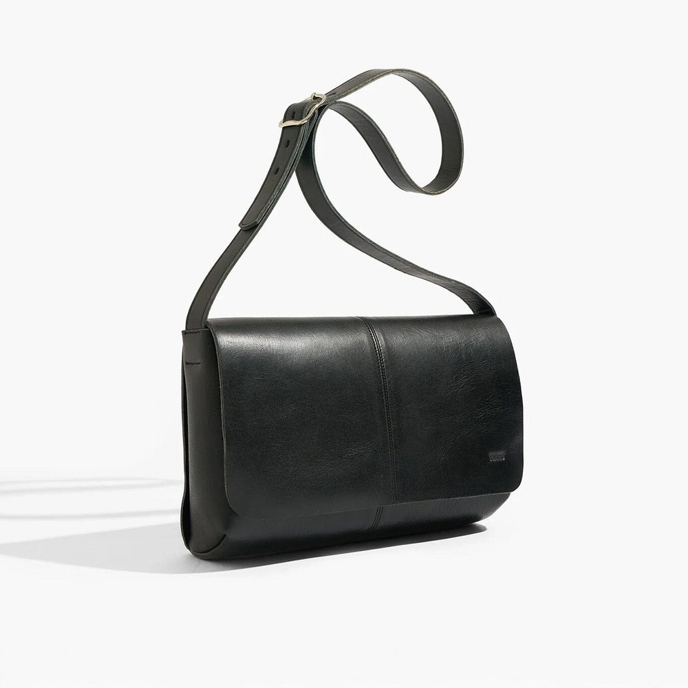 
                  
                    Black leather shoulder bag on a white background
                  
                