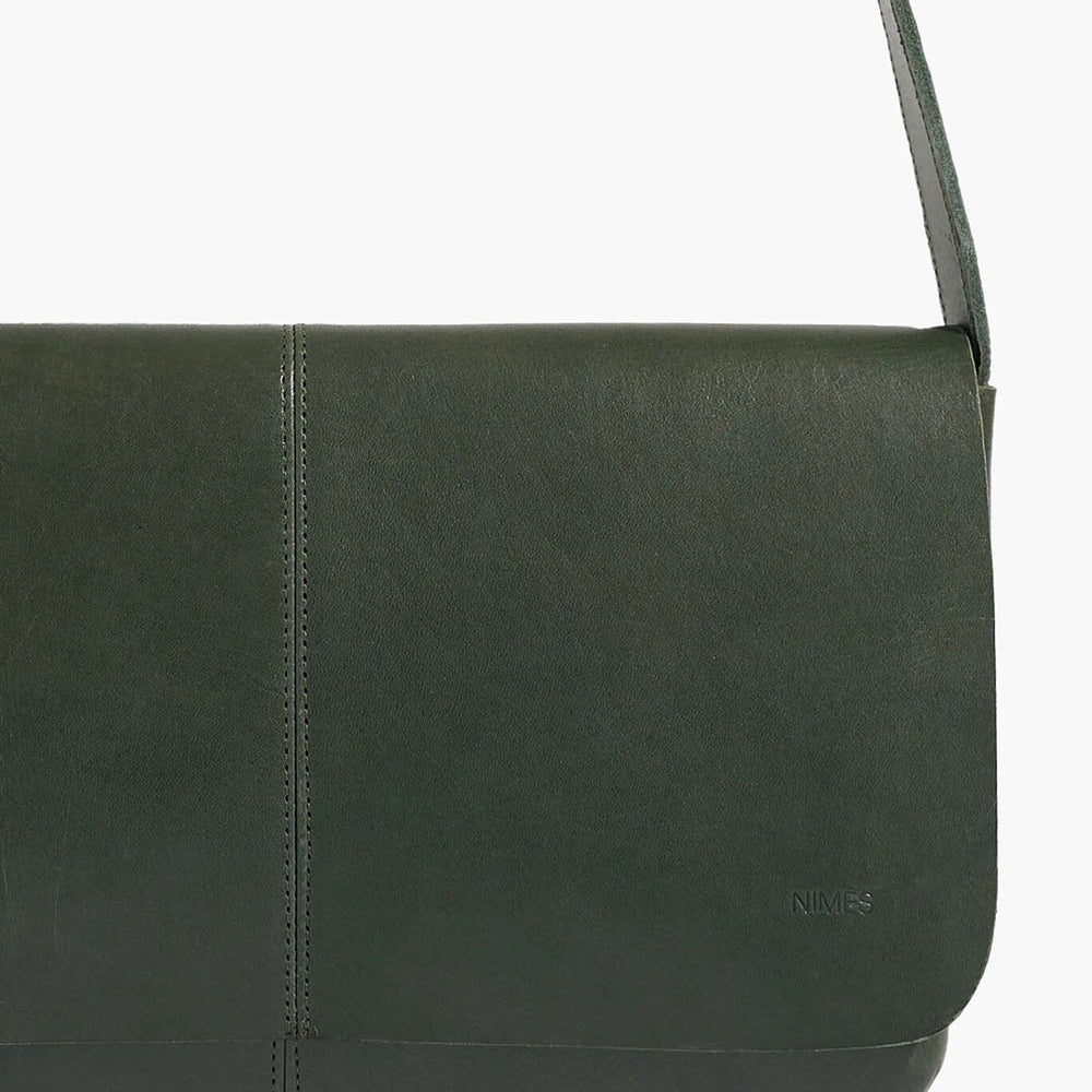 Green leather bag with a strap on a white background