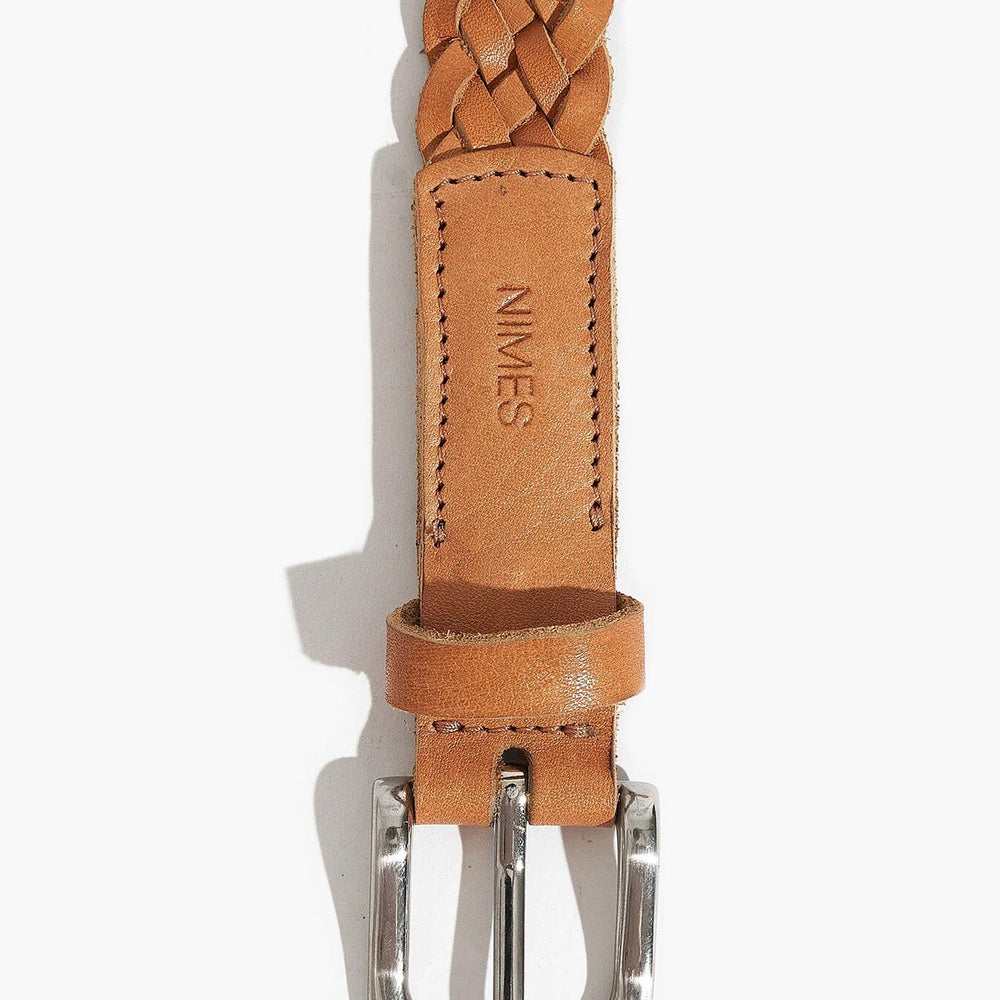 Brown braided leather belt with silver buckle on a white background