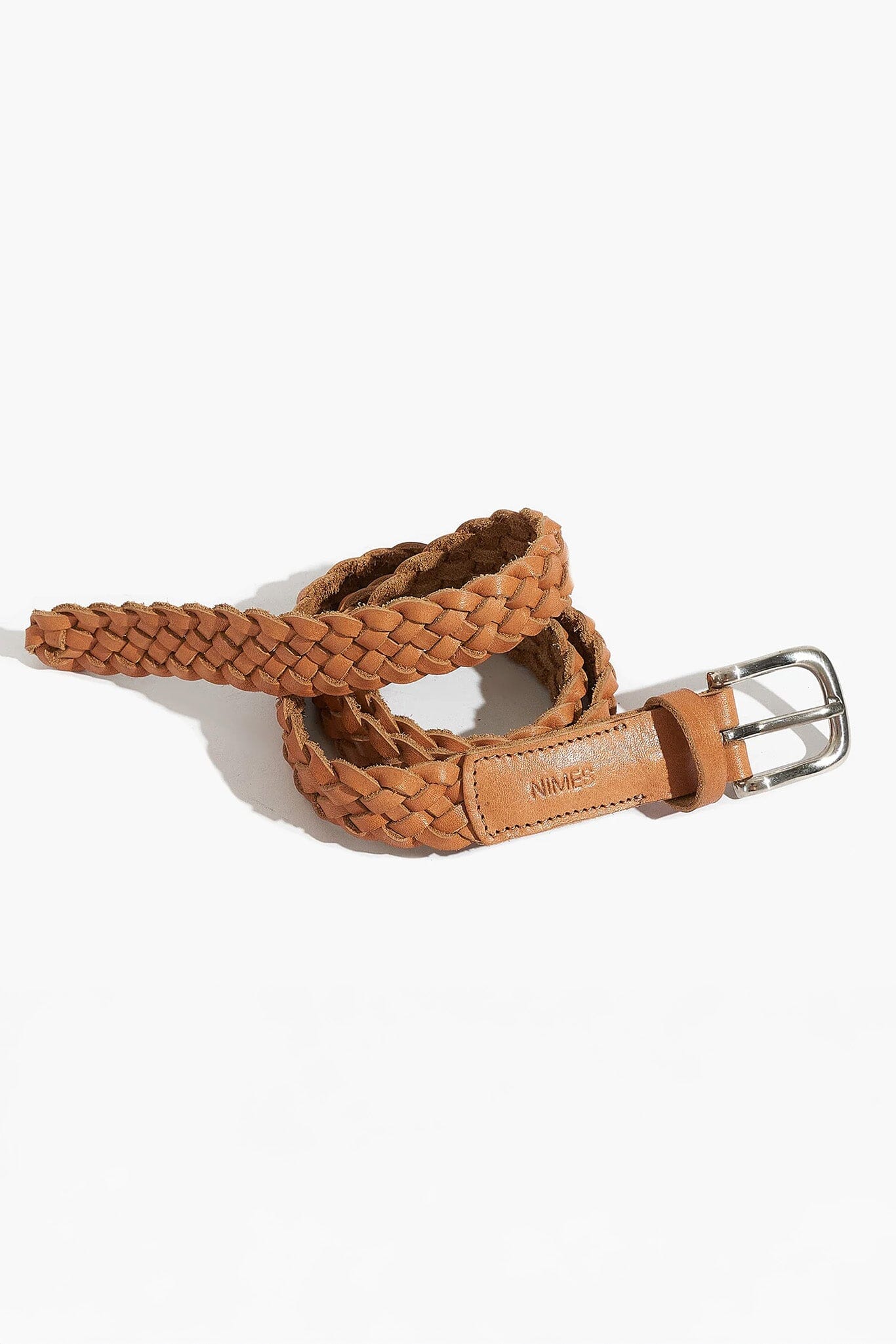 Brown braided belt with silver buckle on a white background