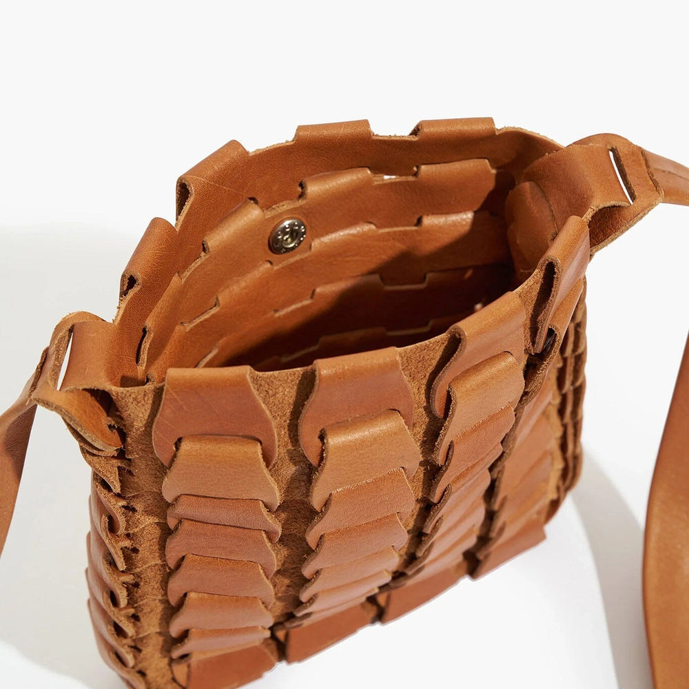 Brown woven handbag on a white background