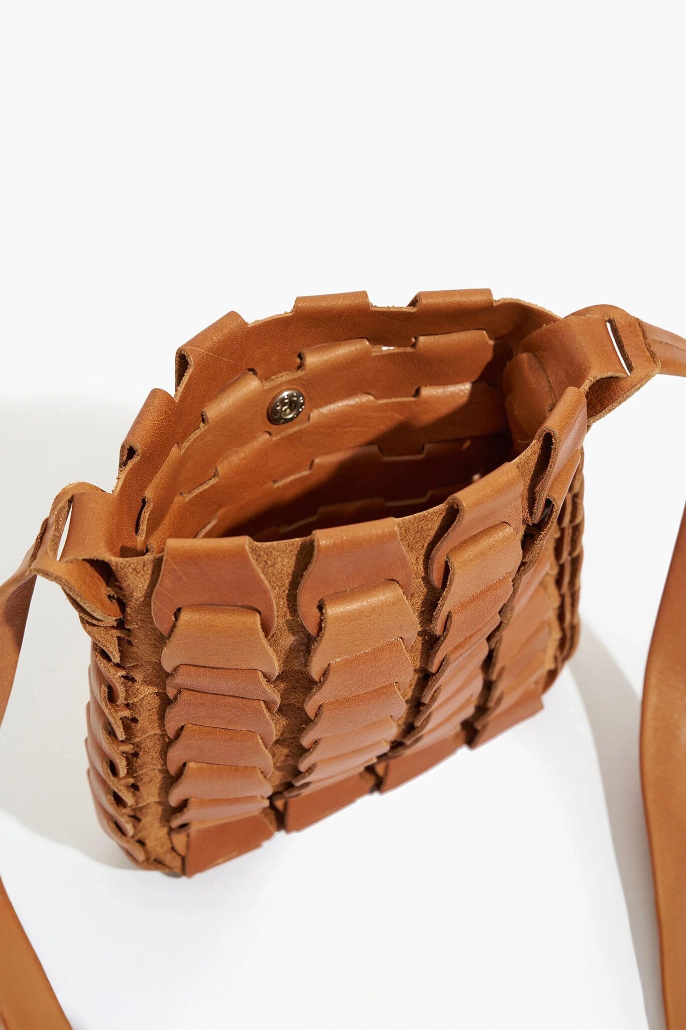 Brown woven handbag on a white background