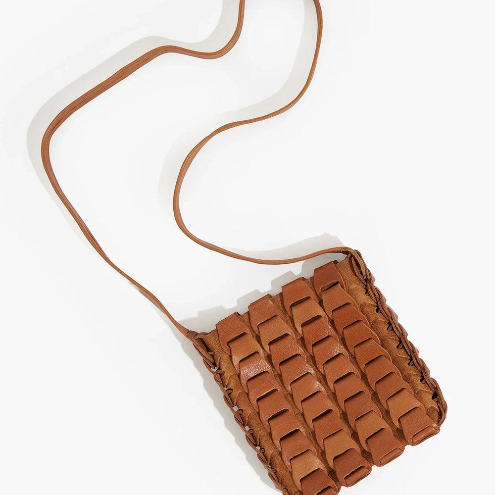 Brown woven handbag with a strap on a white background