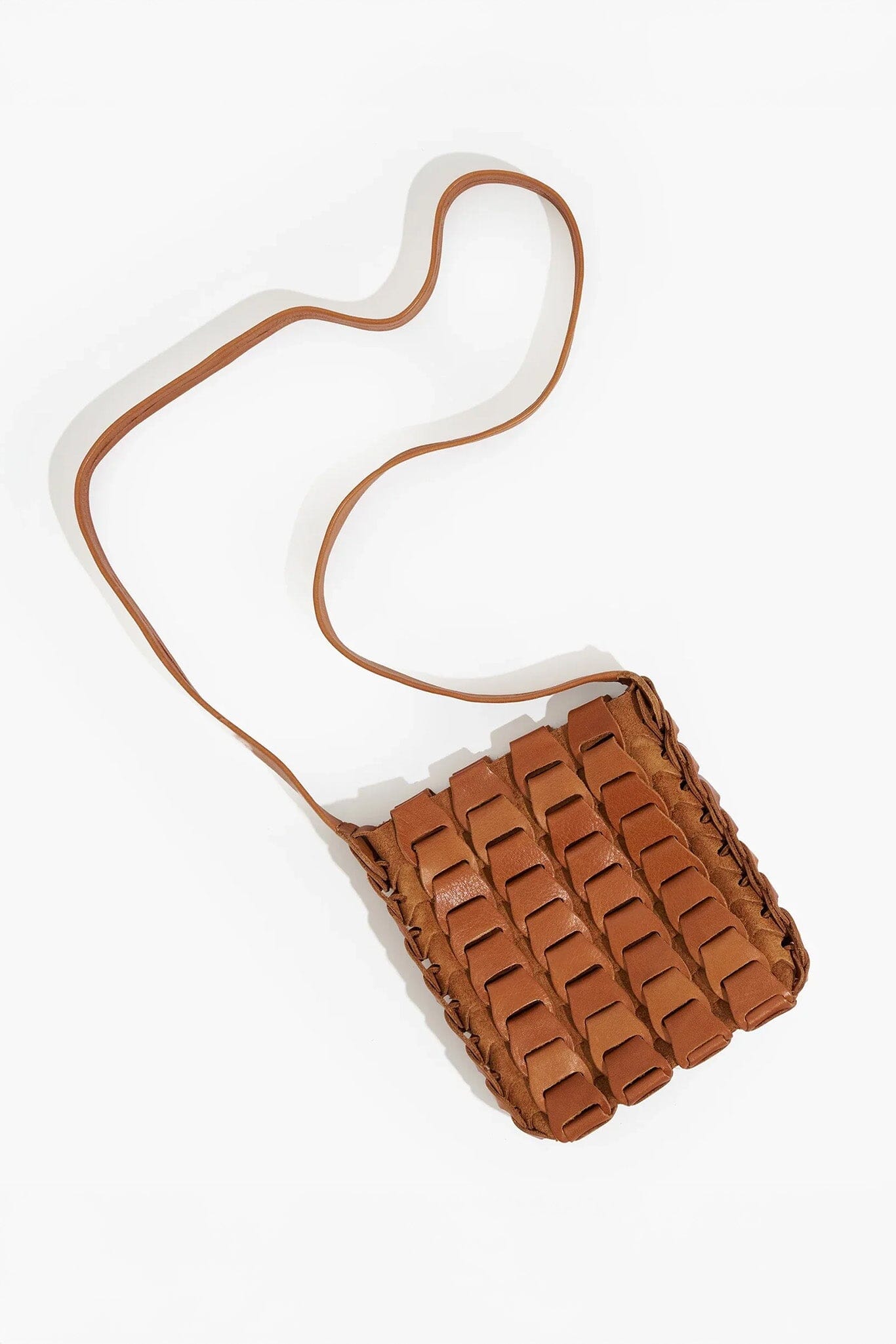 Brown woven handbag with a strap on a white background