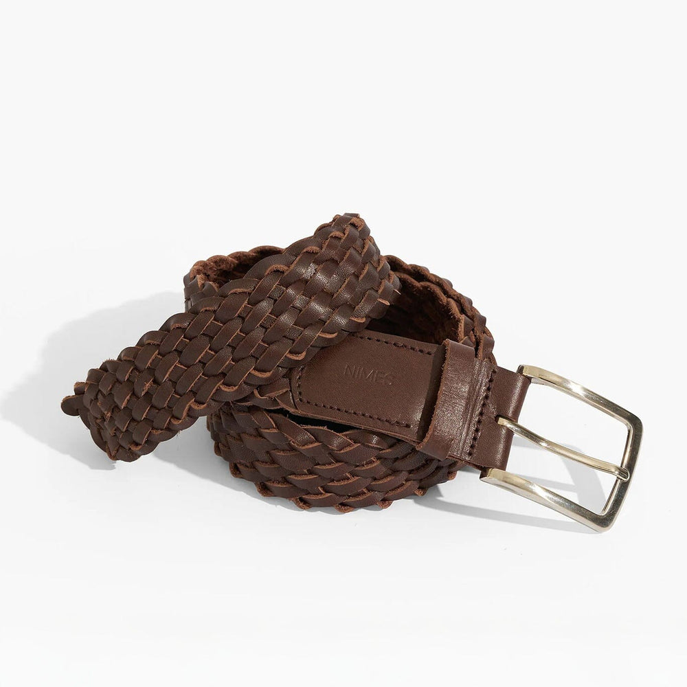 Brown woven belt with a silver buckle on a white background