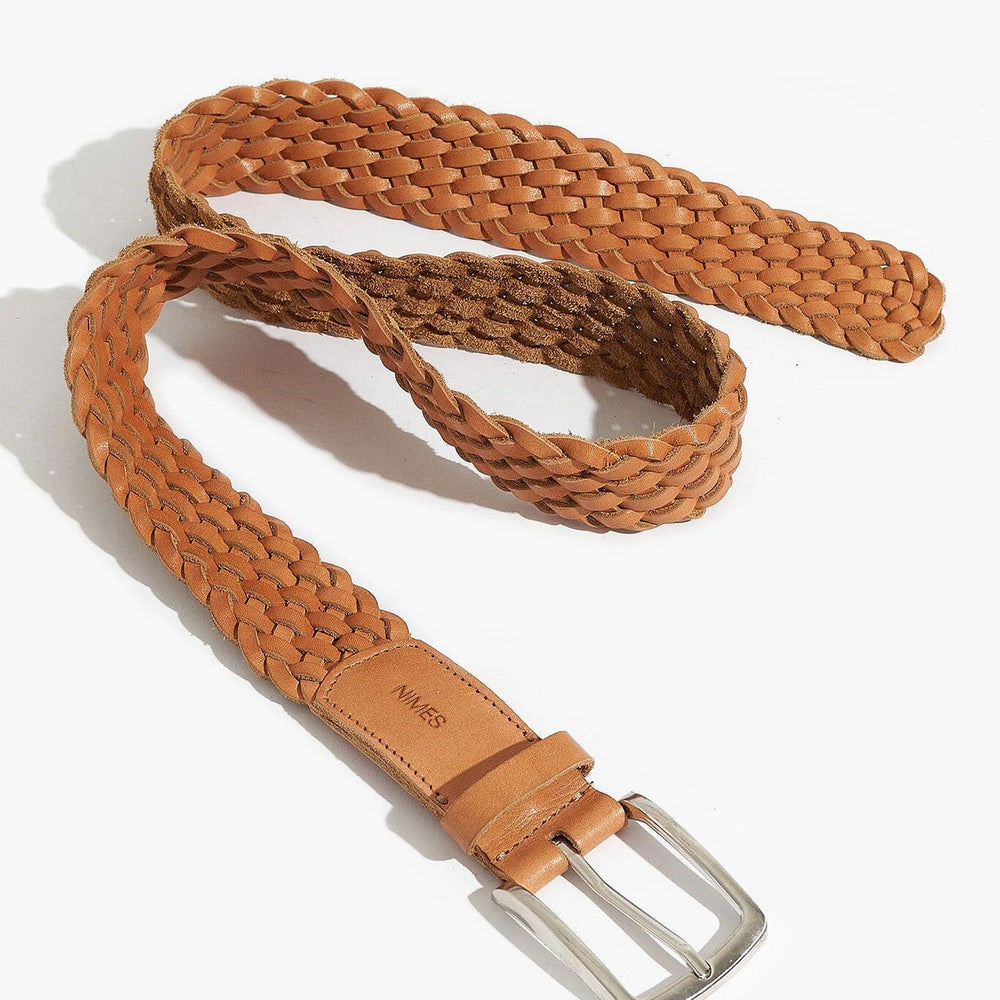 
                  
                    Brown woven belt with a silver buckle on a white background
                  
                