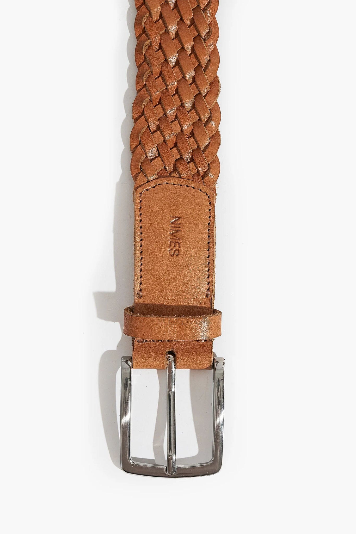 Brown braided belt with silver buckle on a white background
