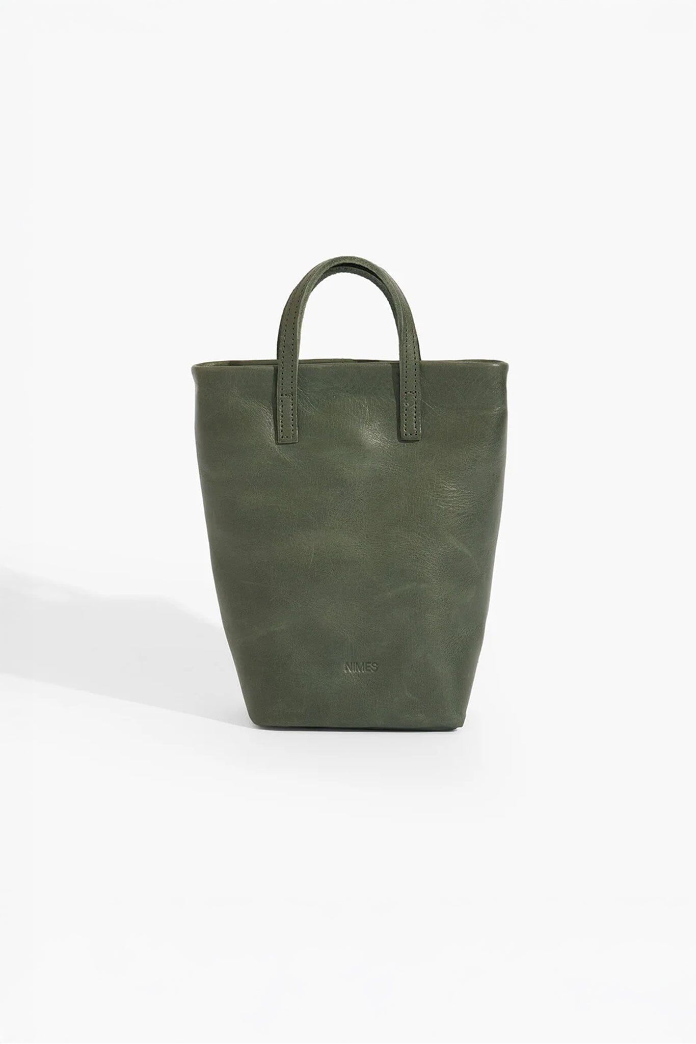 Green leather tote bag on a white background