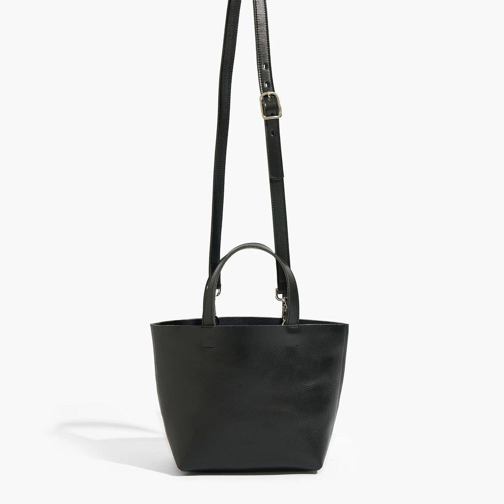 Black handbag with a strap on a white background