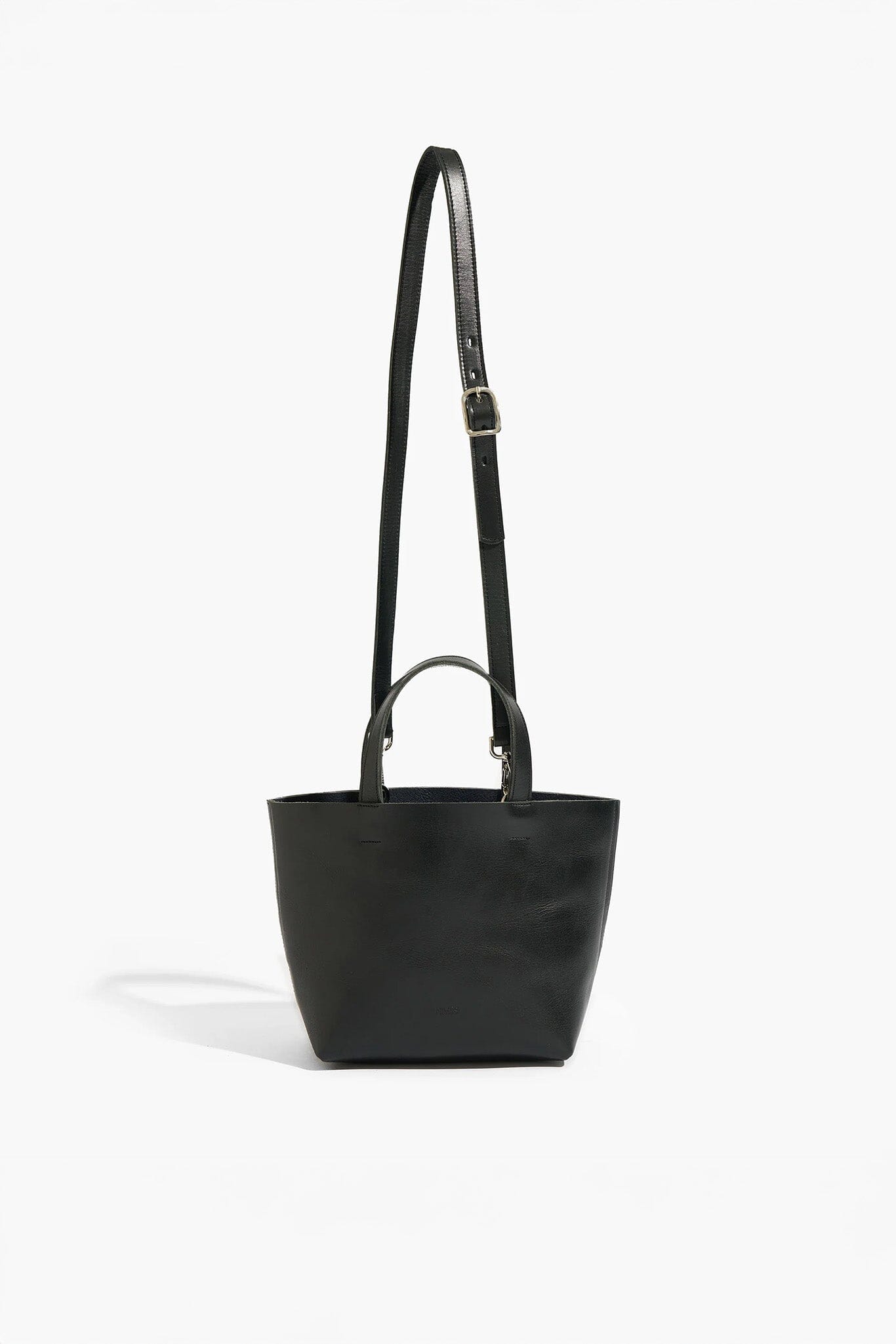 Black handbag with a strap on a white background
