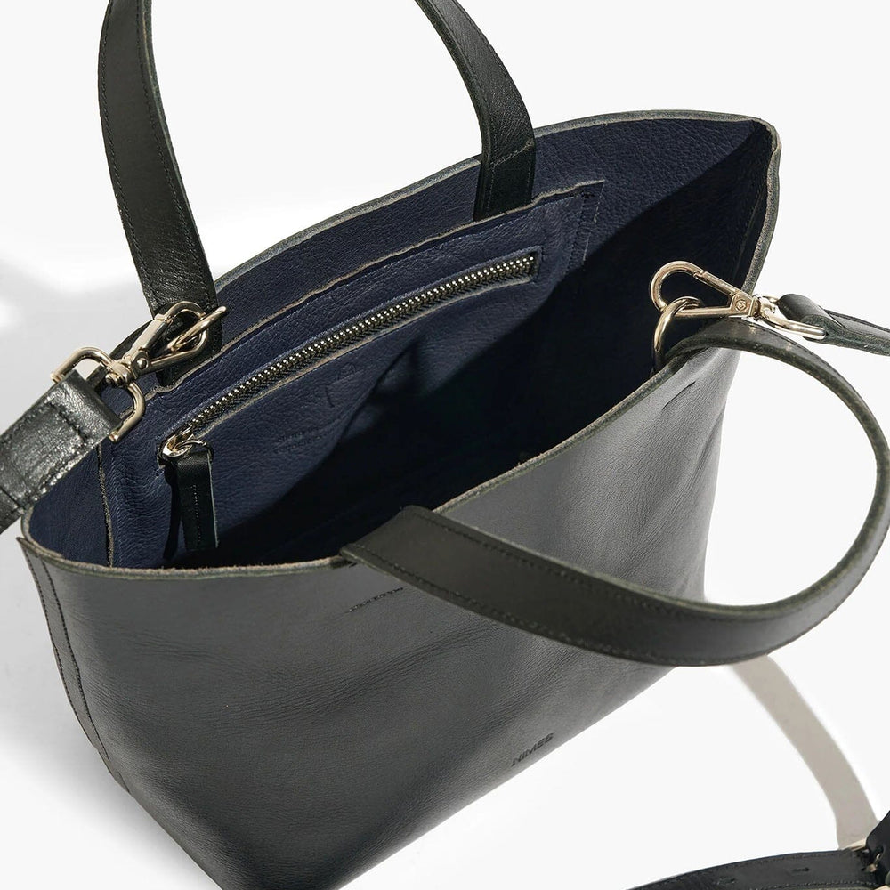 
                  
                    Black handbag with a visible zipper on a white background
                  
                